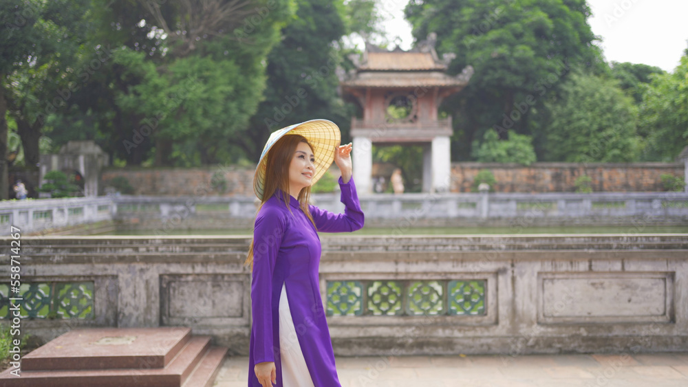 Portrait of Asian Vietnamese woman girl in local temple traveling in Hanoi urban city town, Vietnam. People lifestyle.