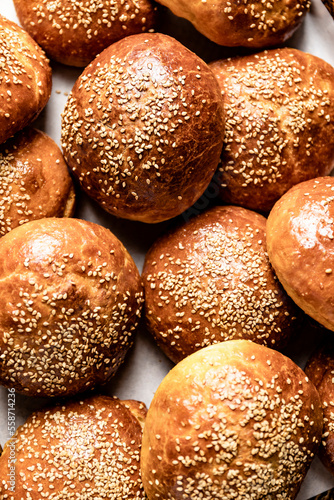 Fresh homemade brioche buns with sesame seed topping photo