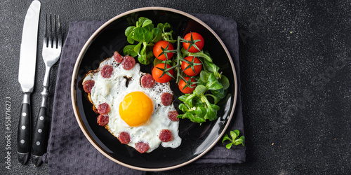 fried eggs vegetables, sausages breakfast fresh healthy meal food snack on the table copy space food background rustic top view