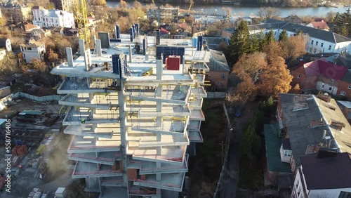 aerial view of construction site of monolithic buildings. Workers work at construction site reinforced concrete structures. Modern industrial monolithic construction