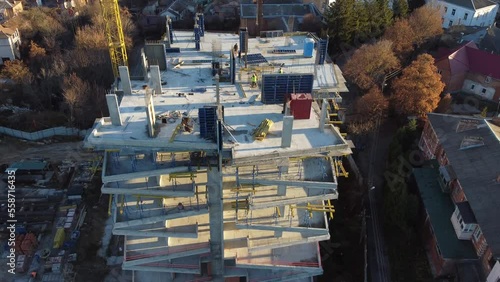 aerial view of construction site of monolithic buildings. Workers work at construction site reinforced concrete structures. Modern industrial monolithic construction