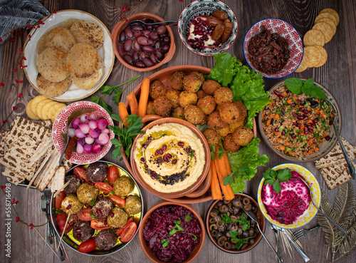 Vegetarian mezze spread consisting of falafel, crudites, tabbouleh, cheese, olives and pickles 