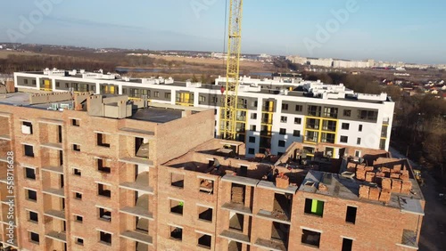 Crane and building under construction against blue sky