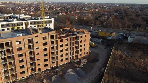 Crane and building under construction against blue sky