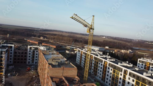 Crane and building under construction against blue sky