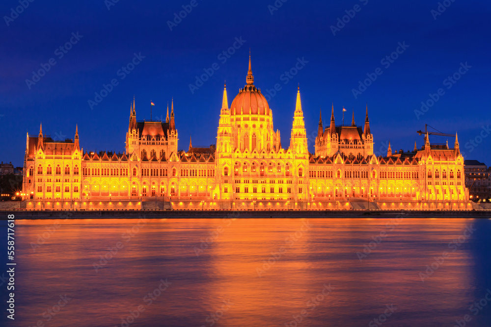 Evening cityscape - view of the Hungarian Parliament Building in the historical center of Budapest on the bank of the Danube river, in Hungary