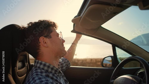Wallpaper Mural Young stylish man in sunglasses driving cabriolet car singing and dancing at golden sunset. Concept of success, tourism and rental. Happy smiling male tourist travel in California. Summer vacation Torontodigital.ca