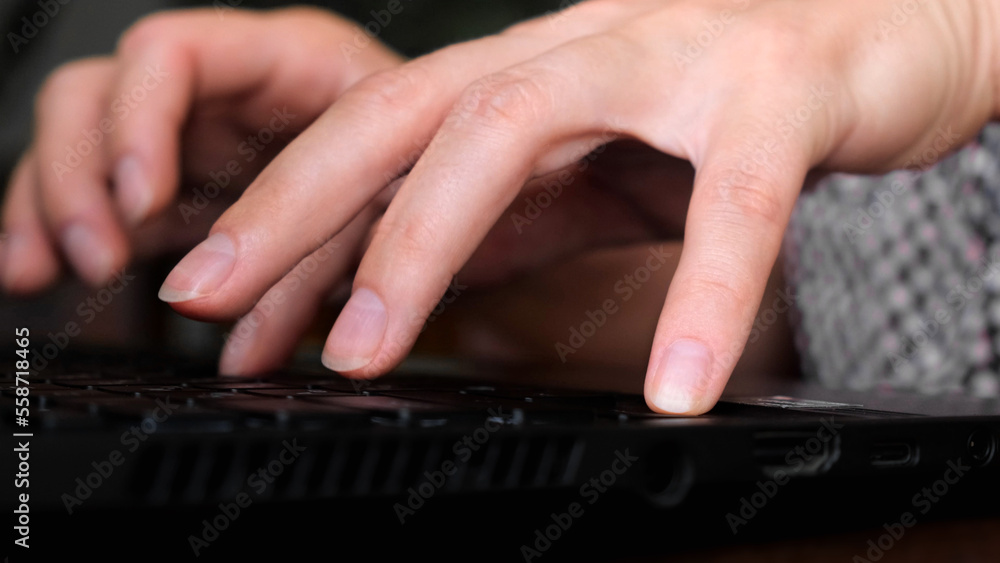 Fingers typing on laptop keyboard close-up. Work at the computer, IT sphere, development or remote online work. Side view Fingers typing on laptop keyboard close-up. Work at the computer, IT sphere, development or remote online work. Side view