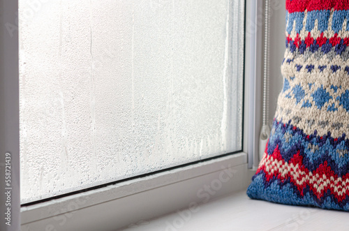drops of condensate on a metal-plastic window. Greenhouse effect. Ecology