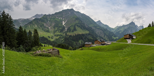 Alpenpanorama mit Wolken und Berghütten