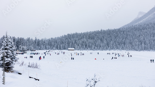 Lake Louise Ice Skaters, Ice Skating on Frozen Lake in Mountains