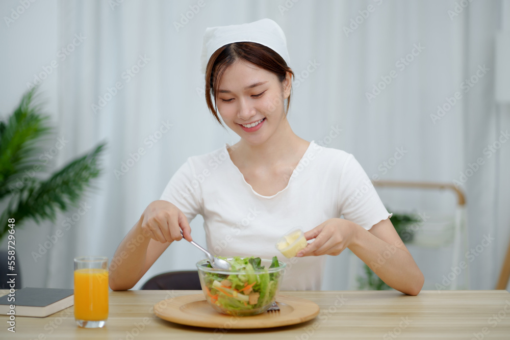 Portrait of happy playful asian girl eating fresh salad in diet concept Portrait of happy playful asian girl eating fresh salad in diet concept