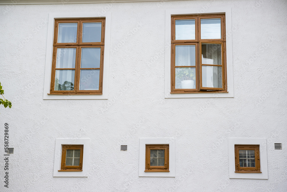 White Wall background with brown windows background texture of house White Wall background with brown windows background texture of house