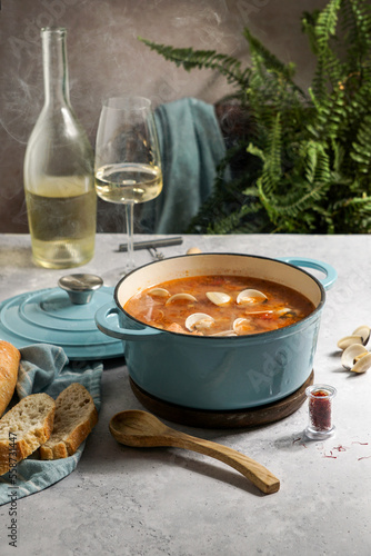 french hot soup Bouillabaisse with clams, fish soup in cast-iron pan