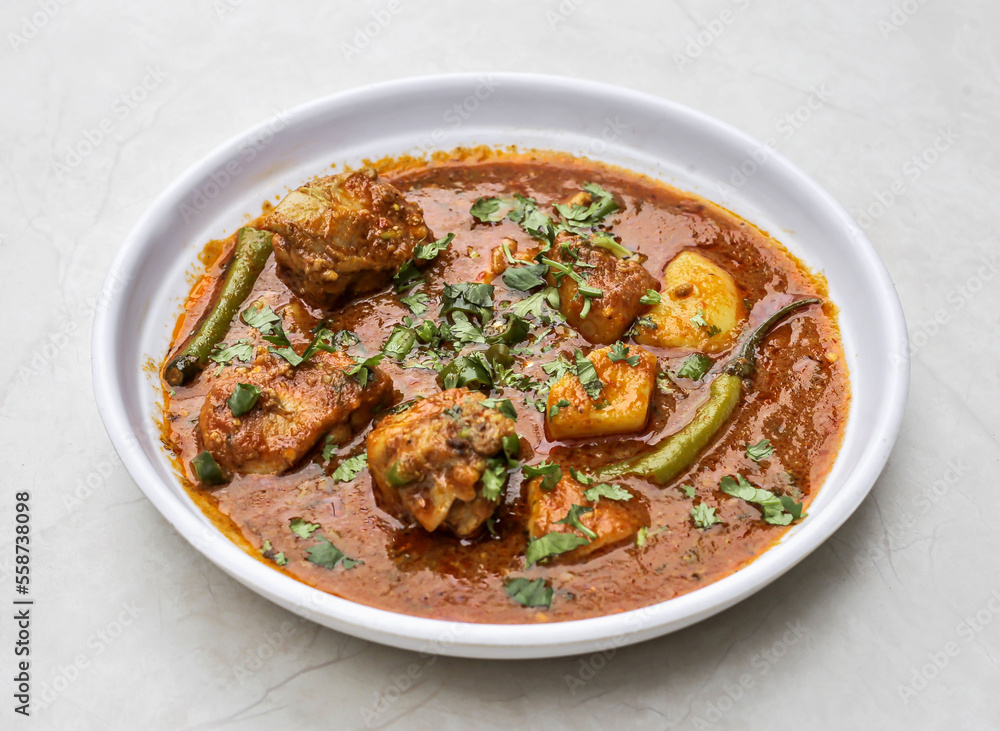 Aloo gosht or meat potatoes served in plate isolated on table top view of indian and pakistani spicy food Aloo gosht or meat potatoes served in plate isolated on table top view of indian and pakistani spicy food