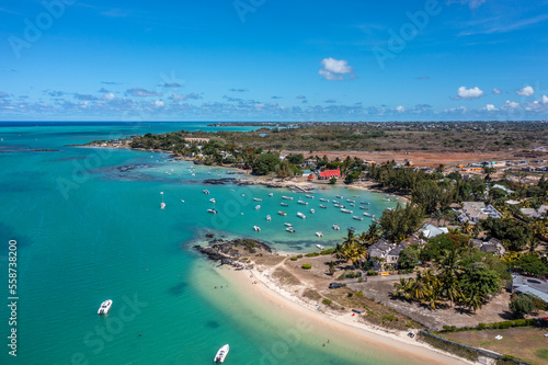 Cap Malheureux, Mauritius - aerial landscape view of Bay, the infrastructure and buildings along the coastline, the Notre-Dame Auxiliatrice de Cap Malheureux and boats on water © Mario Hagen