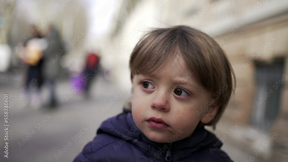 Baby toddler walking in city sidewalk outside during winter Baby toddler walking in city sidewalk outside during winter