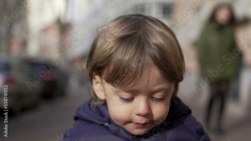 Baby toddler running in sidewalk during winter outside. Infant sprinting in city2