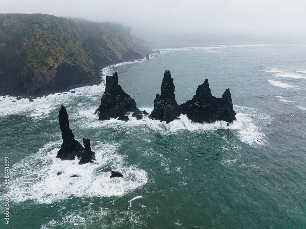 Aerial view of Reynisdrangar rocks, basalt sea stacks situated under ...