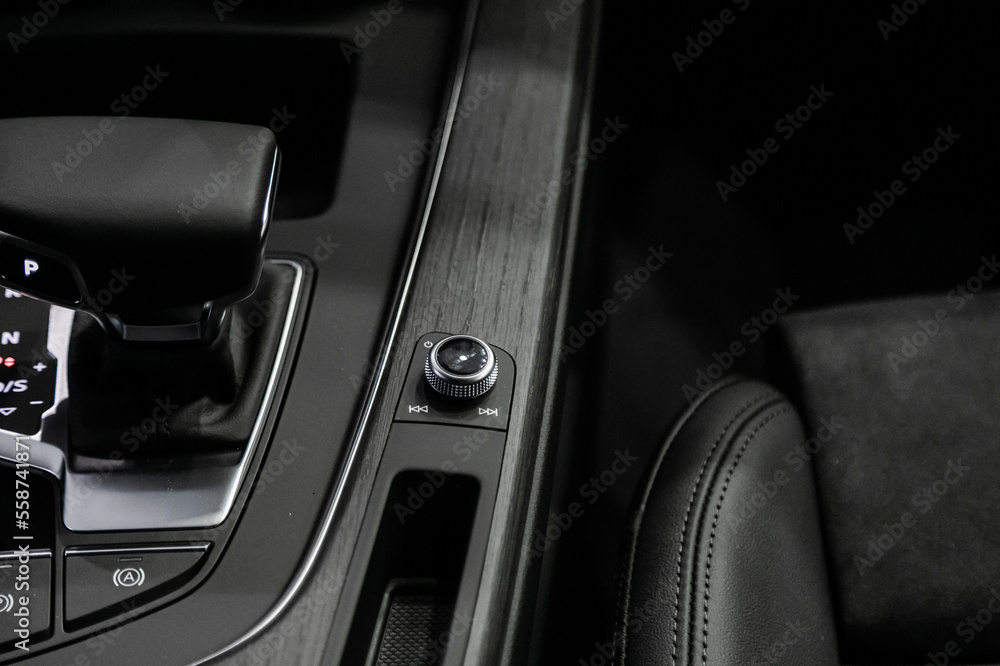 The lever of an automatic transmission in a modern premium car. The center console is finished in wood