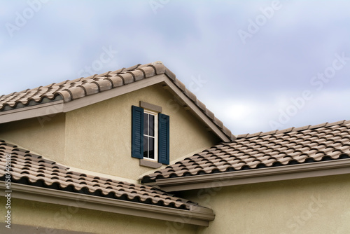 Suburban house attic window with cloudy sky background, Oasis Communication, Menifee, California, USA