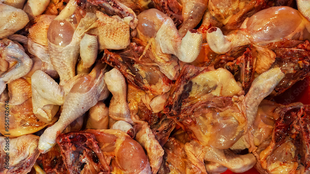 Chicken leg meat at the butcher shop display in traditional market. Raw meat. Chicken leg meat at the butcher shop display in traditional market. Raw meat.
