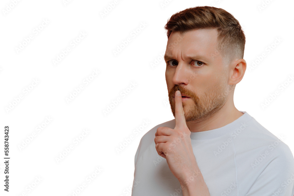 Handsome serious man makes silence gesture presses index finger to lips spreads rumors asks to be quiet looks with strict expression dressed in casual white t shirt isolated over pink background Handsome serious man makes silence gesture presses index finger to lips spreads rumors asks to be quiet looks with strict expression dressed in casual white t shirt isolated over pink background