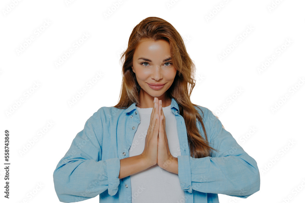 Young woman making namaste gesture isolated on beige background Young woman making namaste gesture isolated on beige background