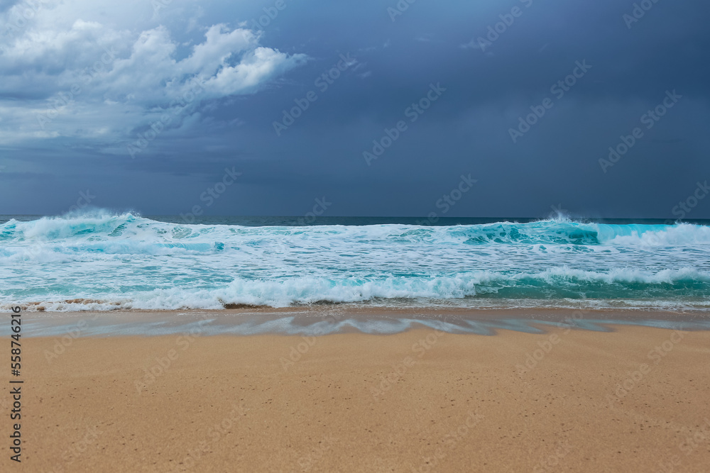Tropical waves on the sea under an overcast sky on the North Shore of Oahu, Hawaii