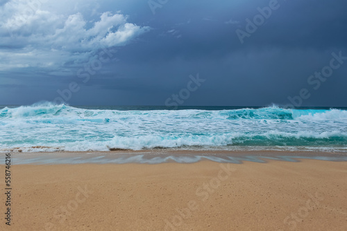 Tropical waves on the sea under an overcast sky on the North Shore of Oahu, Hawaii