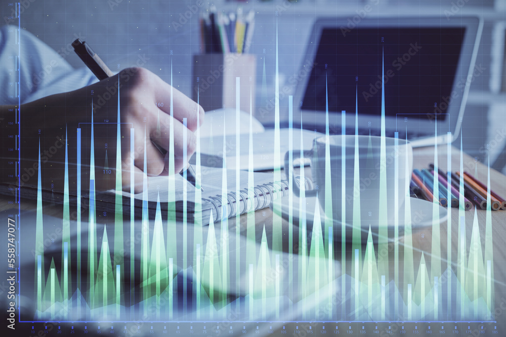 Financial chart drawn over hands taking notes background. Concept of research. Double exposure Financial chart drawn over hands taking notes background. Concept of research. Double exposure