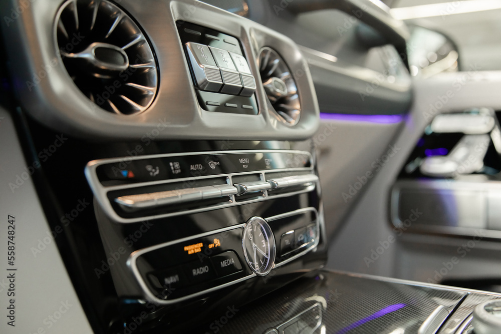 Obraz premium multimedia screen and ventilation system in a well-known expensive premium car with backlight