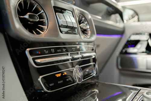 multimedia screen and ventilation system in a well-known expensive premium car with backlight © AvokadoStudio