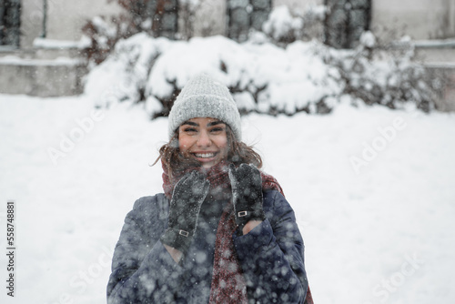 Close-up portrait of happy young woman enjoying winter moments.