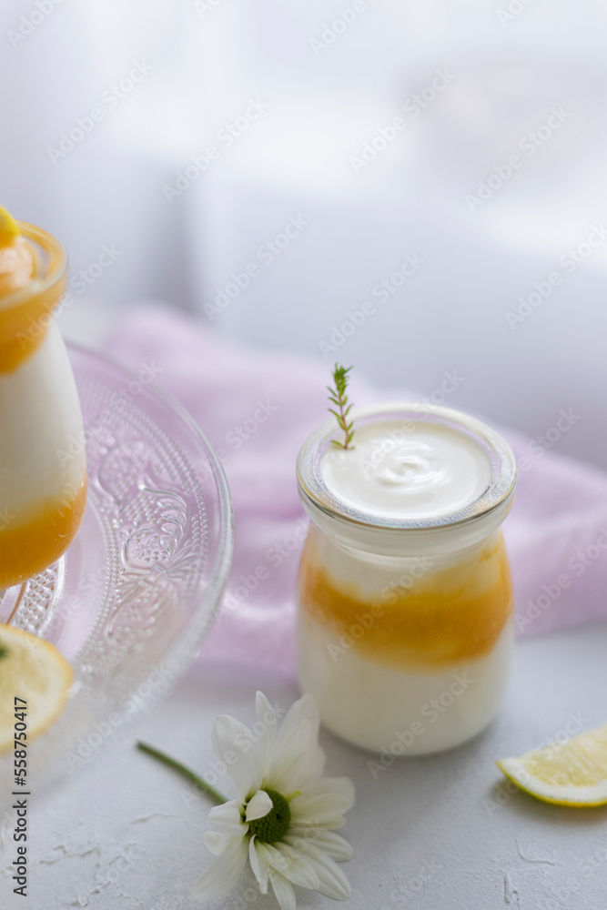 Lemon curd and greek yogurt with thyme in glass jars. Soft romantic scene. Lemon curd and greek yogurt with thyme in glass jars. Soft romantic scene.