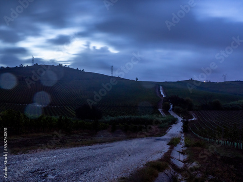 A cold dawning is rising over a countryside road, following in between valleys - Pereiro de Palhacana - Alenquer - Portugal photo