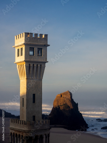 A vertical frame of the Tower, next to the "penedo do Gincho" landmarks of the village of Santa Cruz, located in Silveira, Torres Vedras – Portugal.
