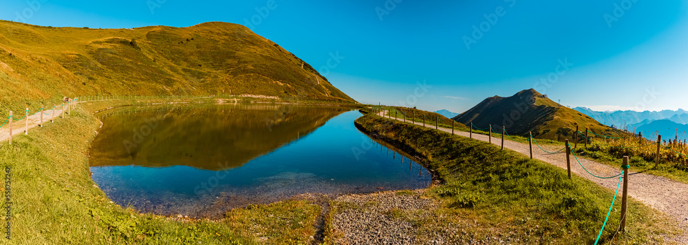 High resolution stitched panorama with reflections in a lake at the famous Kanzelwand summit, Riezlern, Vorarlberg, Austria