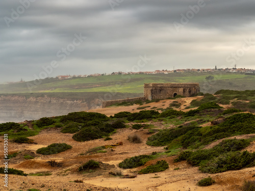 Milreu’s fort, located in-between the Mil Regos and Alibaba’s beaches, under a cloudy sky. Ericeira – Portugal photo