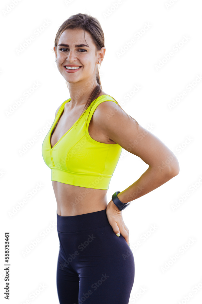 Attractive young Spanish woman standing over transparent background in sport bra and pants looking at camera smiling satisfied by body shape. Successful European brunette fit girl at morning workout.