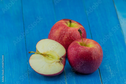 close-up apple on blue wooden background photo