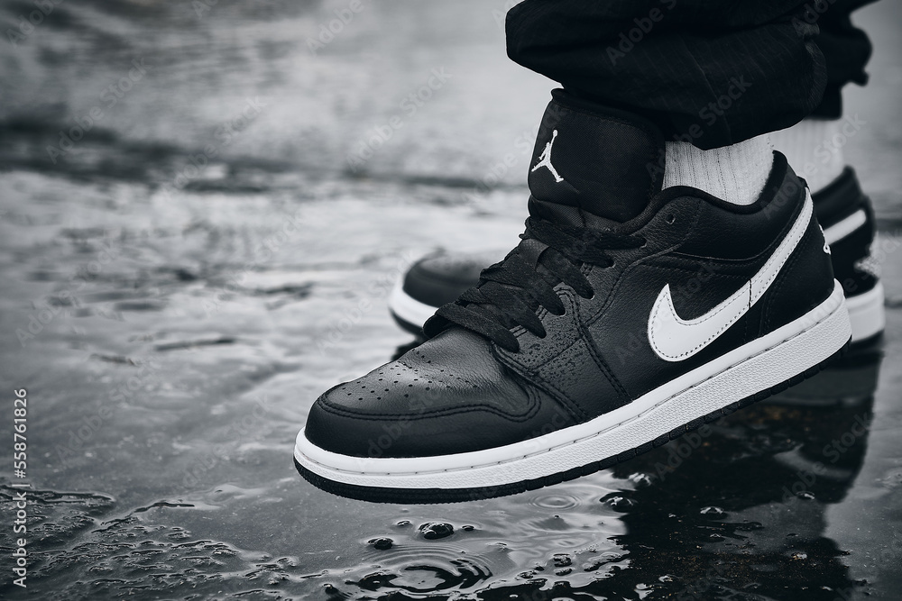 On-feet Nike Air Jordan I Black White on wet surface illustrative editorial  Stock 写真 | Adobe Stock