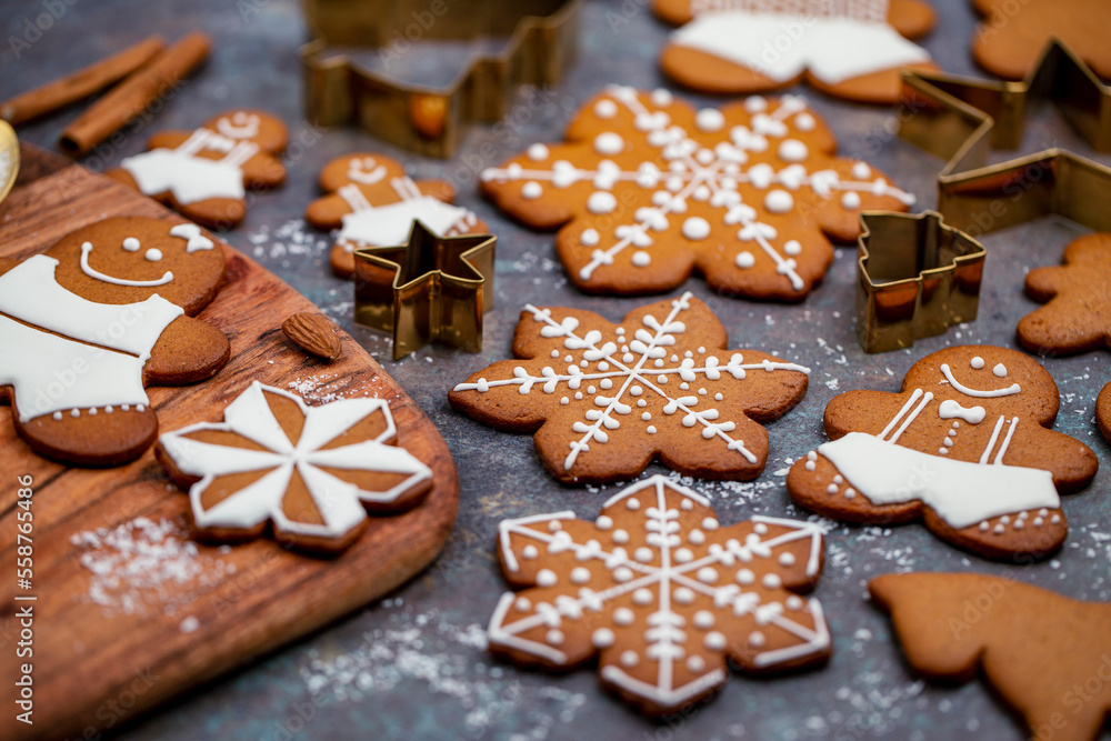 Christmas gingerbread cookies baking and decorating on kitchen table Christmas gingerbread cookies baking and decorating on kitchen table
