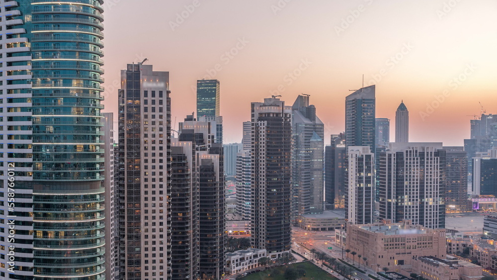 Fototapeta premium Dubai's business bay towers aerial day to night timelapse. Rooftop view of some skyscrapers