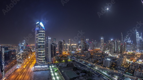Dubai s business bay towers aerial all night timelapse. Rooftop view of some skyscrapers