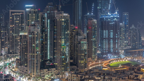 Futuristic aerial all night cityscape timelapse with illuminated architecture of Dubai downtown  United Arab Emirates.