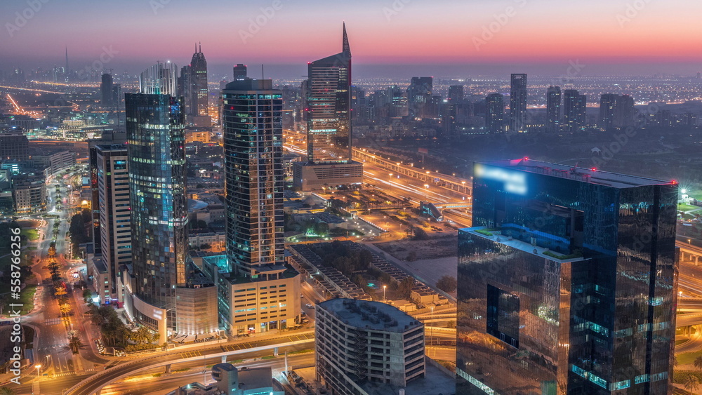 Aerial view of media city and al barsha heights district area night to day timelapse from Dubai marina.