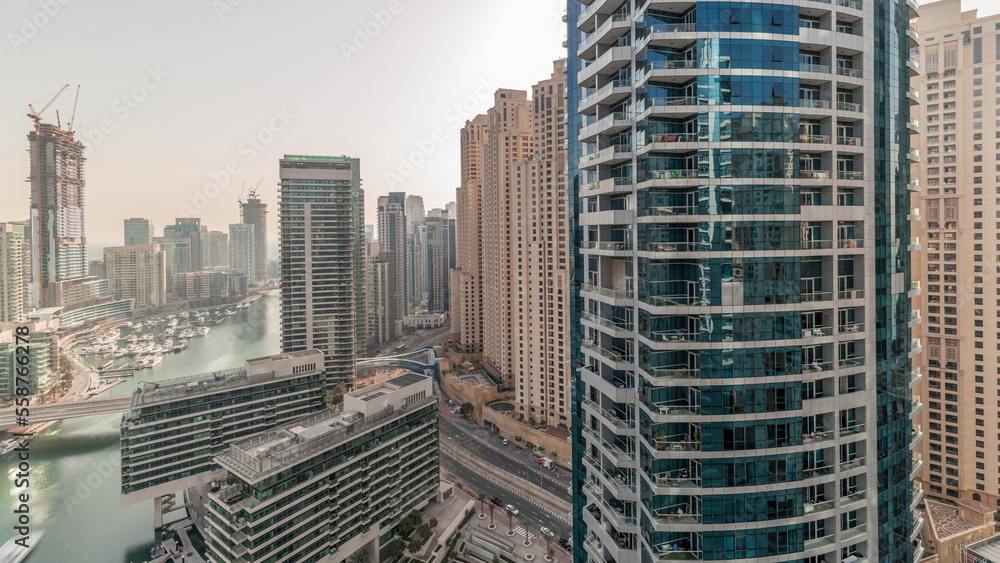 Panorama showing overview to JBR and Dubai Marina skyline with modern high rise skyscrapers waterfront living apartments aerial timelapse