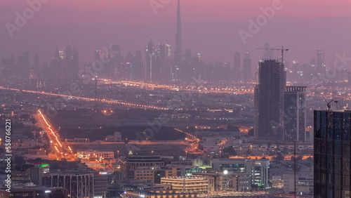 Dubai Downtown skyline row of skyscrapers with tallset tower aerial night to day timelapse. UAE