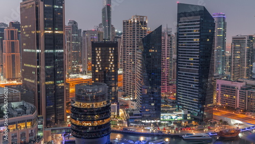 Dubai Marina Skyline with JLT district skyscrapers on a background aerial night to day timelapse.